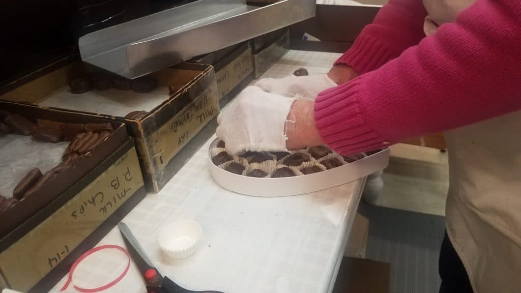 Janet Wittich Places Chocolates into a Heart Shaped Box