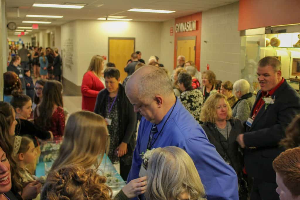 Guests Line Up for a Corsage (Photo Courtesy of Travis Mitchell)