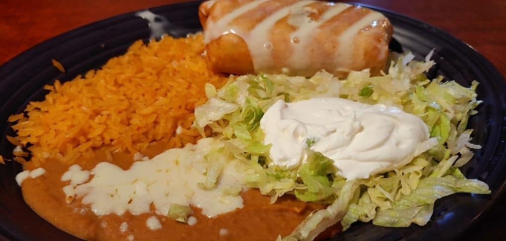 Enchilada with Beans, Rice, Lettuce and Sour Cream from El Palomar Mexican Restaurant