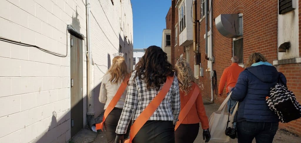 Miss Pumpkin Show and her Court walking to Lindsey's Bakert